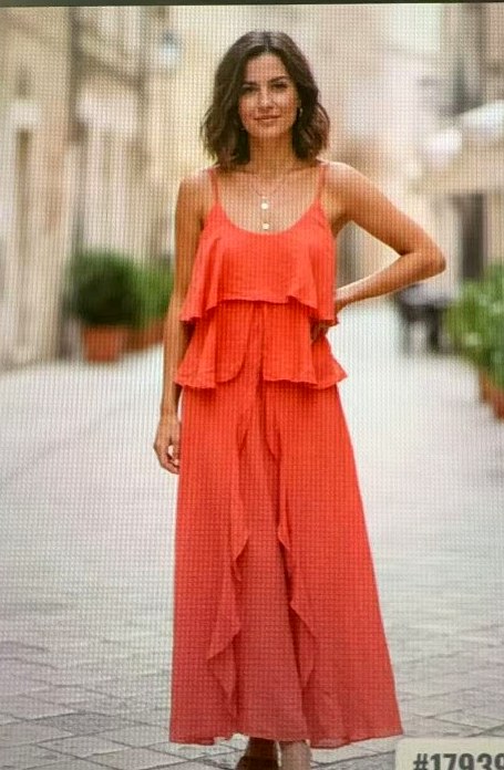 Model in a coral ruffled linen maxi dress on a European street