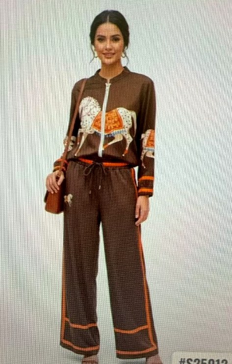 Model in a brown zip bomber and wide-leg pants with horse print and orange piping